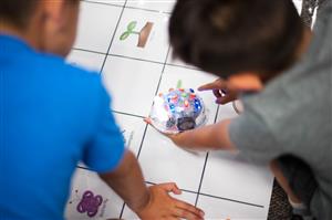 Students using Blue-bots to learn coding. 