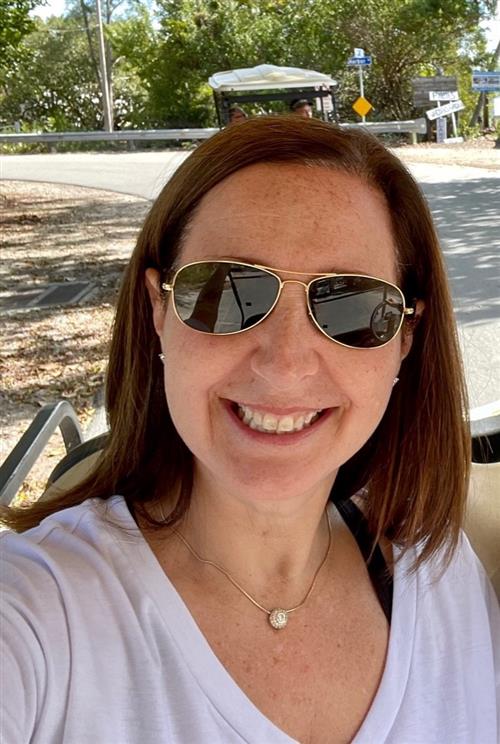 woman smiling wearing sunglasses