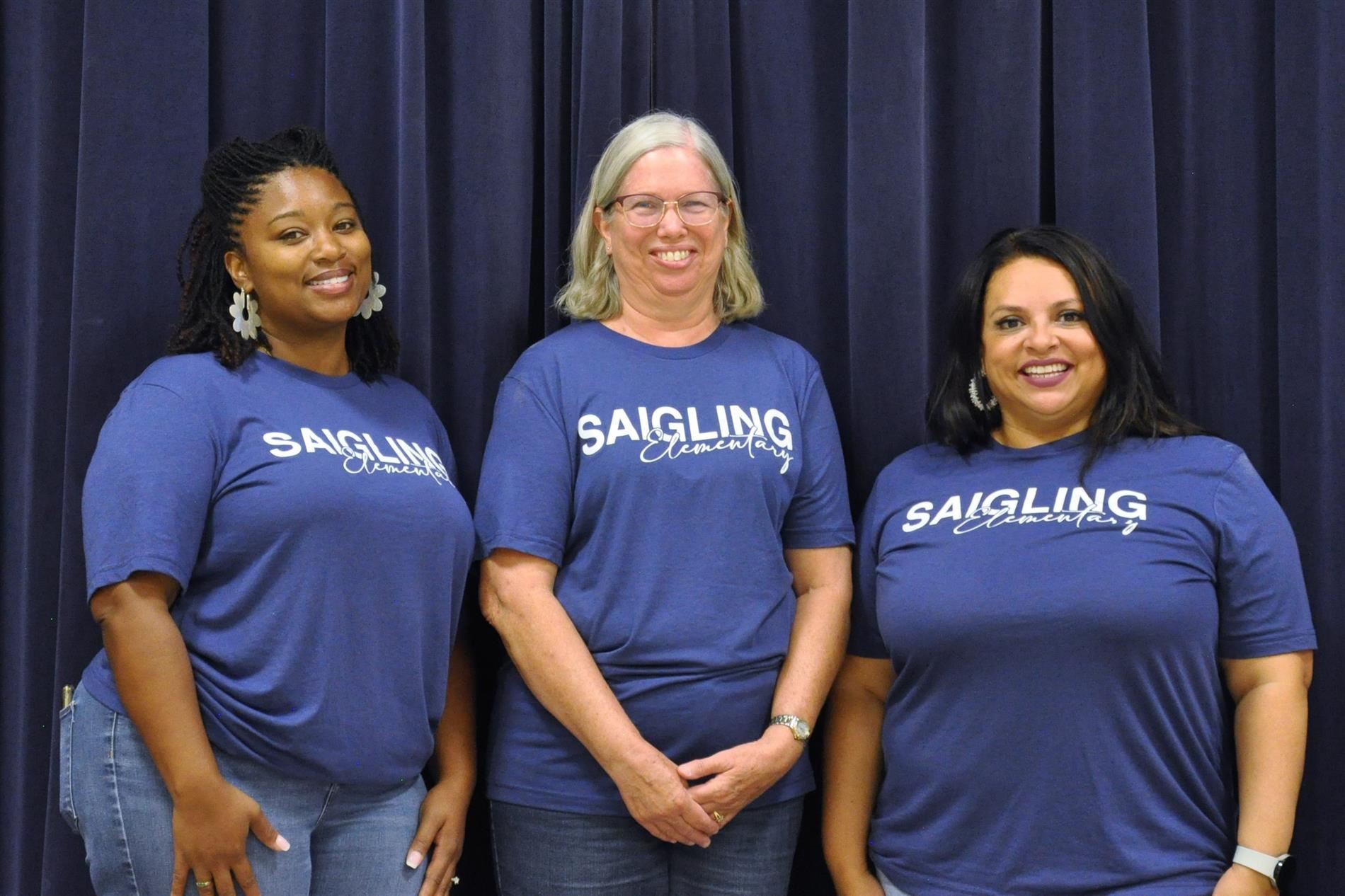 A picture of Ms. Ruffin, Ms. Oliveri, and Ms. Ayala standing next to each other smiling.