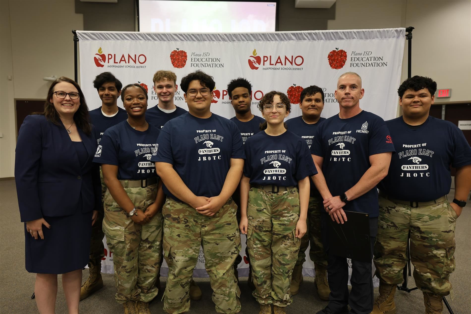 Members of the Plano East JROTC robotics team posing with Dr. Lauren Tyra