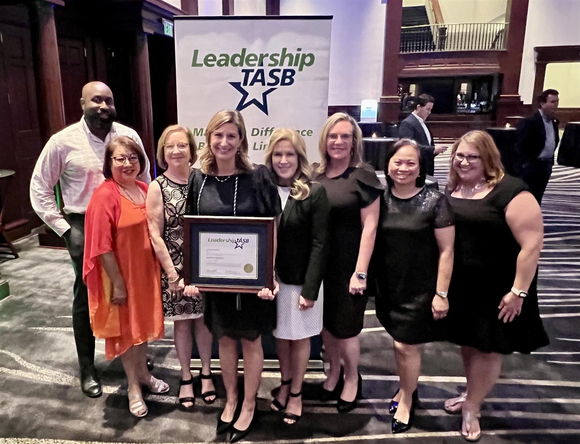Image of Trustee Chambers with her certificate, Plano ISD trustees and administrators