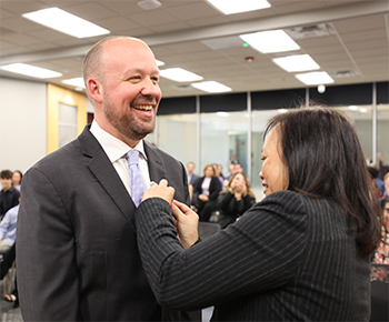 Former Trustee Angela Powell pinning new trustee Sam Johnson